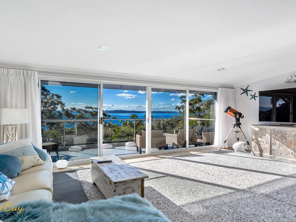 a living room with a view of the ocean at Water Views on Wallawa in Nelson Bay