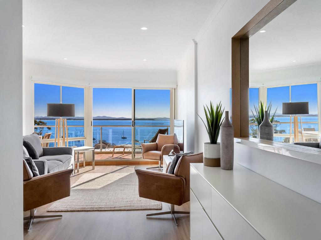 a living room with a view of the ocean at Breakwater Apartment 403 in Shoal Bay