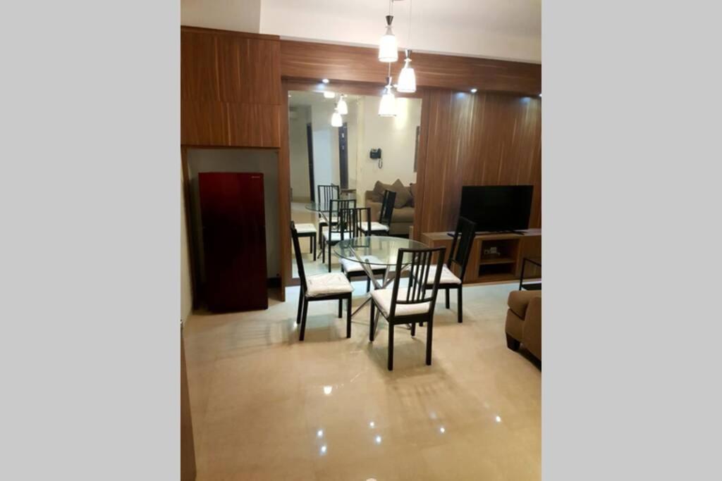 a dining room with a table and chairs at Simple and luxury one bedroom apartment lavenue by sang living in Jakarta