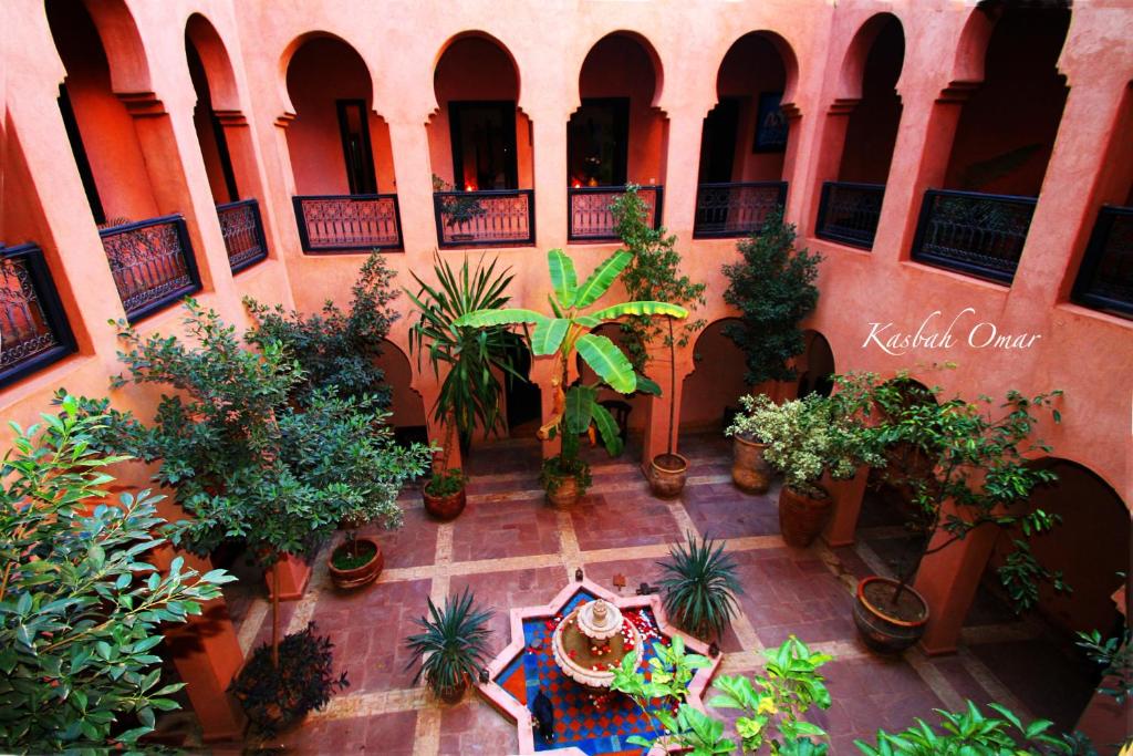 an indoor courtyard with potted plants in a building at Riad Kasbah Omar in Ourika