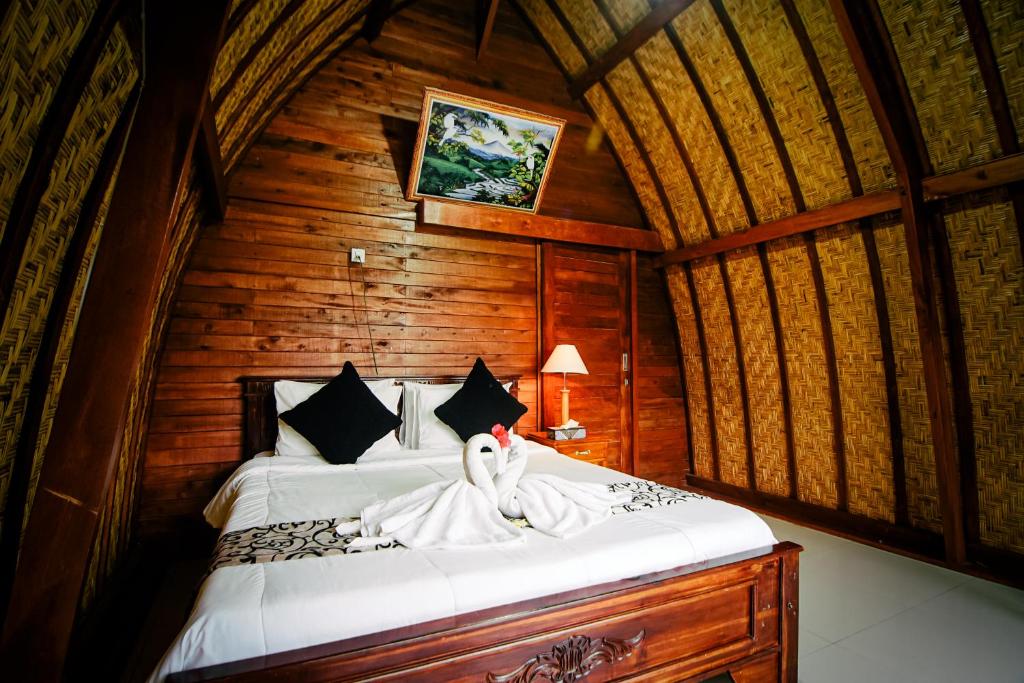 Postel nebo postele na pokoji v ubytování Pondok Bali Cottage