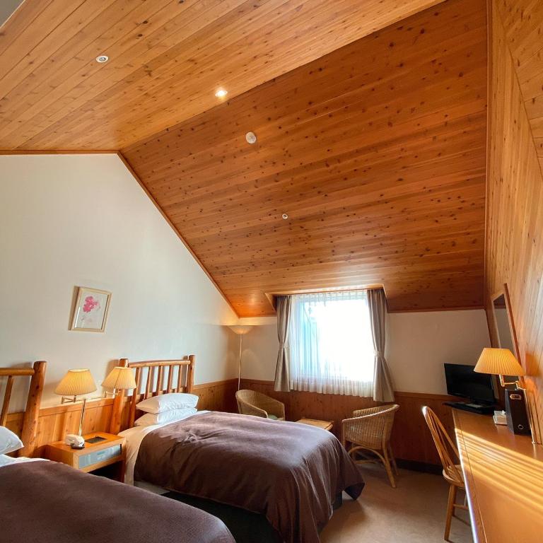 Postel nebo postele na pokoji v ubytování Kibi Kogen Resort Hotel