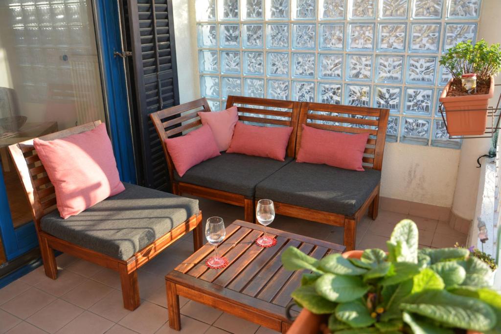 a porch with two chairs and a table and a table sidx sidx at Apartma San Izola - near the beach San Simon in Izola