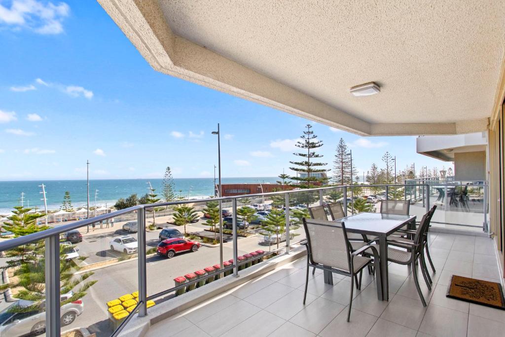 a balcony with a table and chairs and a view of the ocean at Suite 310 Sandcastles 3 Bedroom Deluxe in Perth