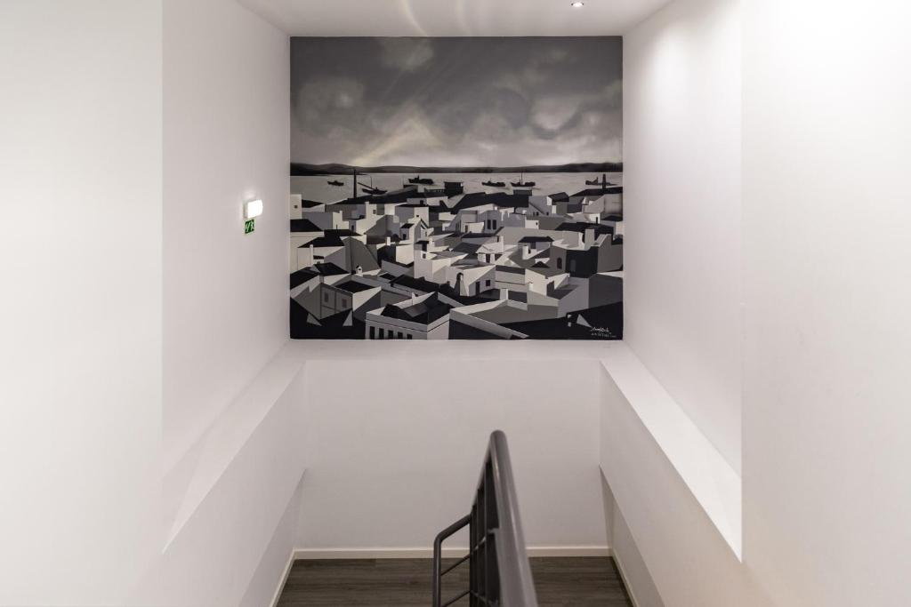 Uma TV ou centro de entretenimento em Hotel Cidade de Olhão