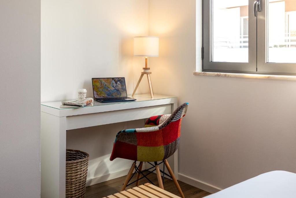 Cama ou camas em um quarto em Hotel Cidade de Olhão