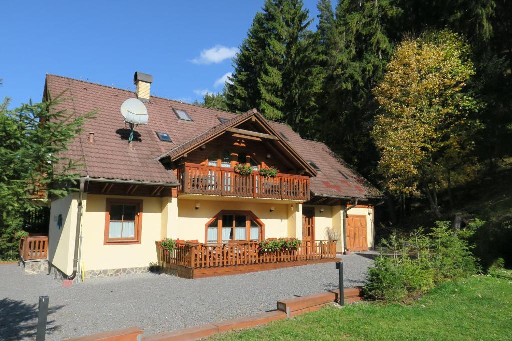 a house with a deck and a balcony at ALFA in Demanovska Dolina