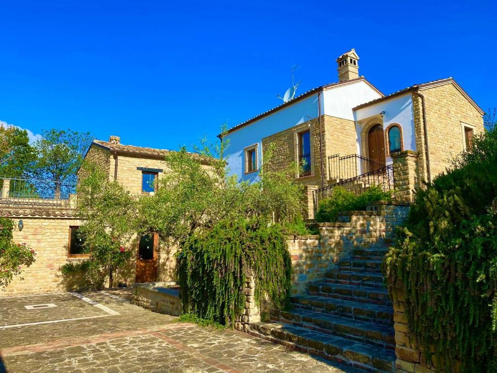 una vecchia casa con le scale di fronte di agriturismo borgo del ginepro a Castiglione Messer Raimondo