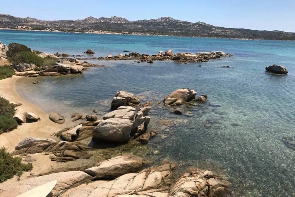 a beach with rocks in the water and the ocean at Giardinelli Vacanze La Maddalena, SARDEGNA, Italia in La Maddalena