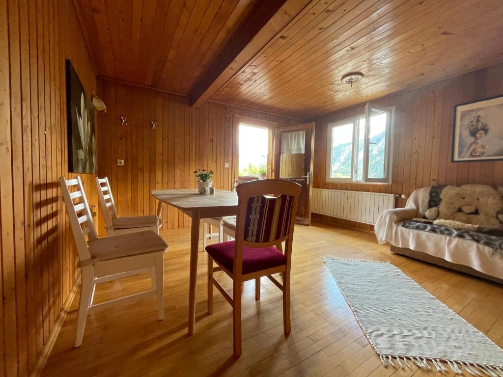 a living room with a table and chairs and a couch at Rosa - Huusa im Bregenzerwald in Au im Bregenzerwald