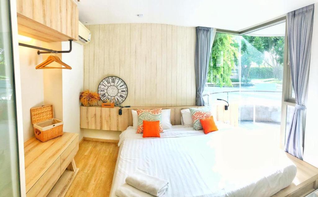 een slaapkamer met een bed en een groot raam bij บ้านแสนคราม in Ban Huai Sai Tai