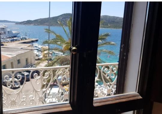 a window with a view of the ocean from a balcony at BELVEDERE in La Maddalena