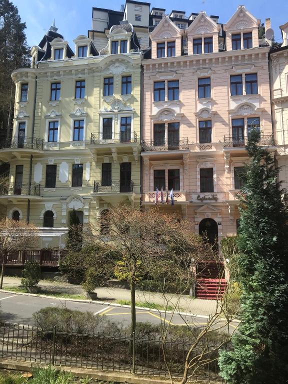 a large building with people standing on the balcony at Apartment Sadova in Karlovy Vary