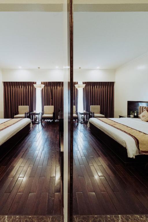 Postel nebo postele na pokoji v ubytování White Palace Thai Binh Hotel