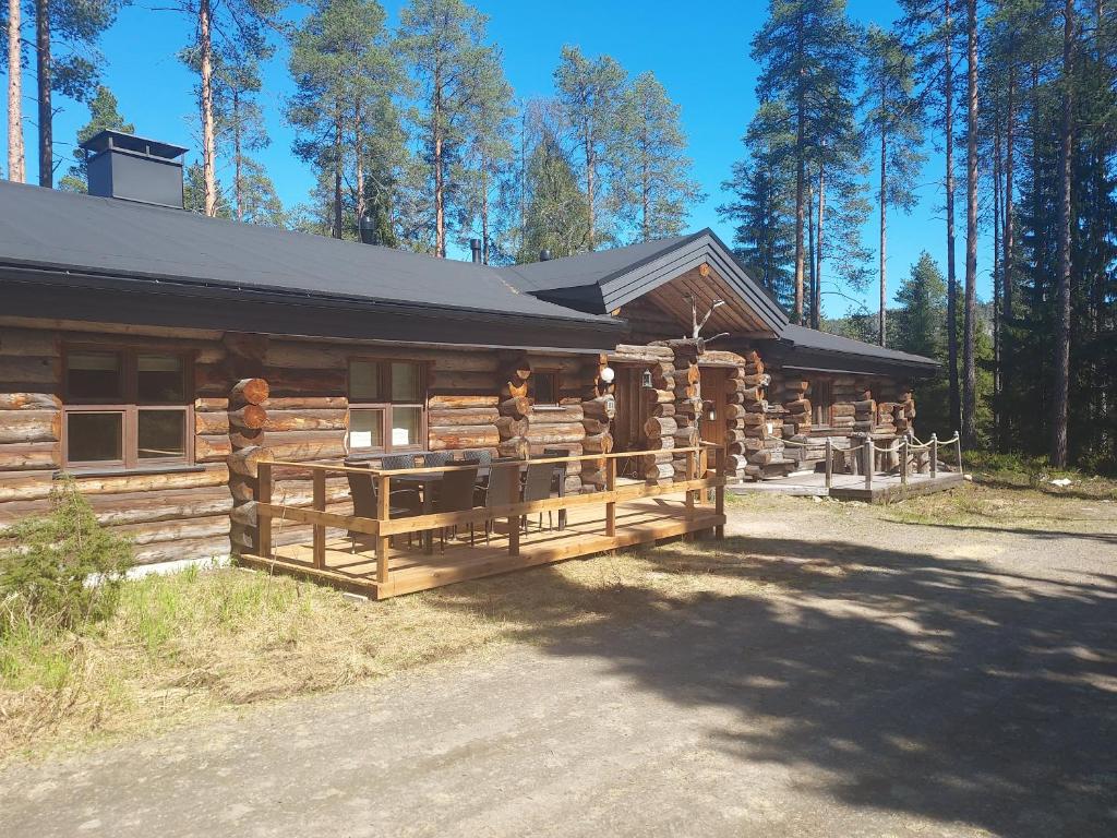 a log cabin with a fence in front of it at Ruka Aava in Ruka