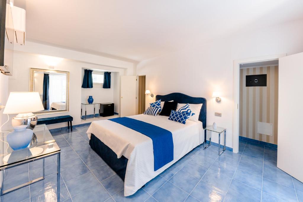 a bedroom with a large bed with blue tiles at BeB Palazzo Mancini in Minori