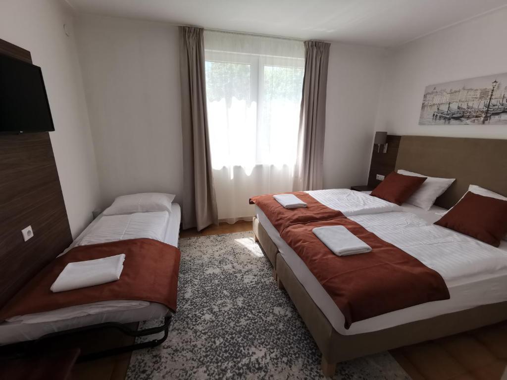 Postel nebo postele na pokoji v ubytování Laguna Panzió