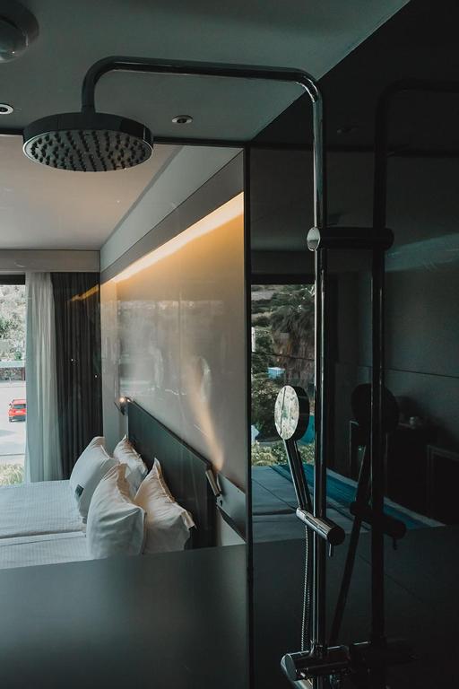 a bedroom with a bed with a large mirror at H Boutique Peña Parda in La Herradura