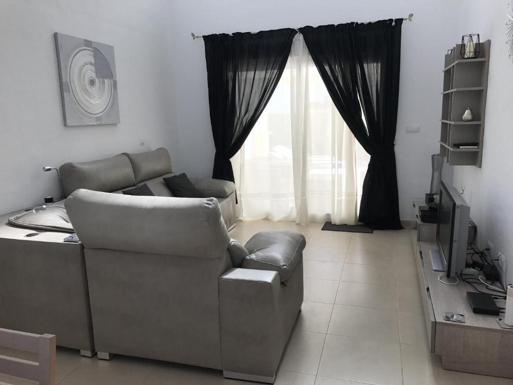 a living room with a couch and a window at Villa Pagel - A Murcia Holiday Rentals Property in Roldán