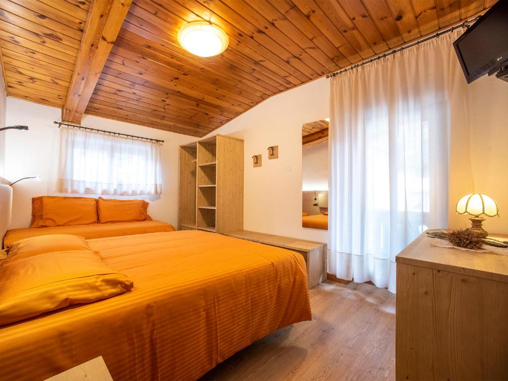 Postel nebo postele na pokoji v ubytování Hotel Adriana