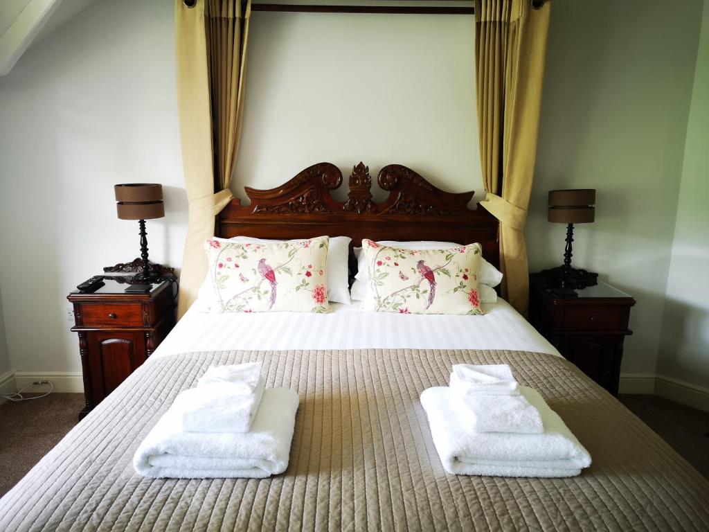 a bedroom with a bed with towels on it at Aberconwy House B&B in Betws-y-coed