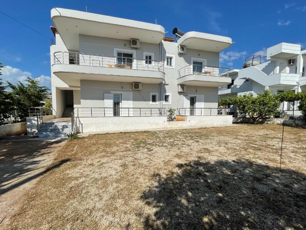 a large white building with a yard in front of it at Villa Almando in Ksamil
