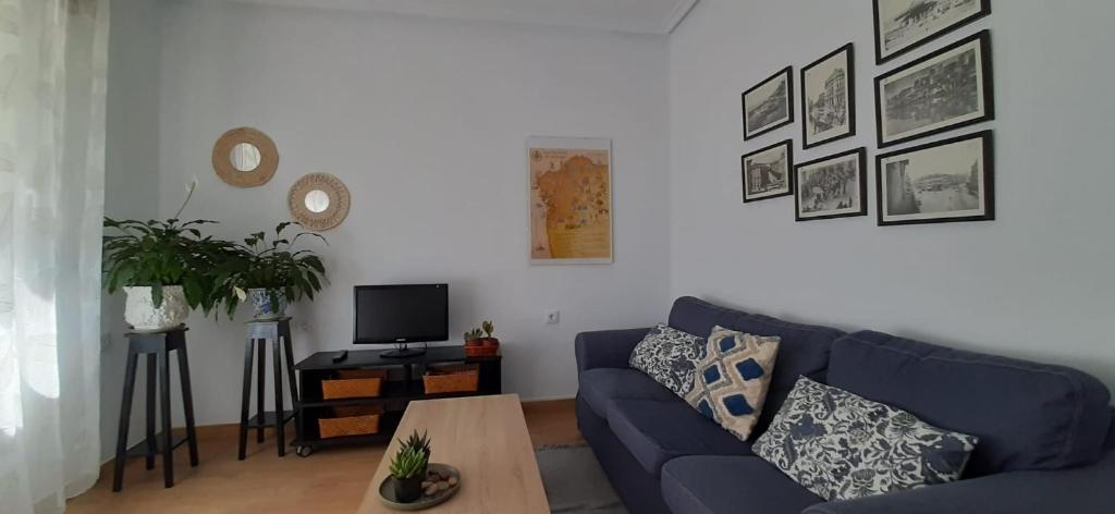 een woonkamer met een blauwe bank en een tafel bij Casablanca 95 in Vigo