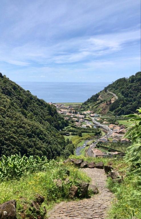 a view of a winding river in a valley with trees at Casa Auri in Faial da Terra