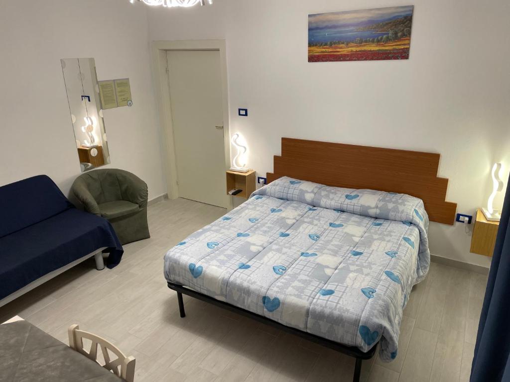 - une chambre avec un lit, un canapé et une chaise dans l'établissement B&B del Corso - Affittacamere GIULIANOVA, à Giulianova