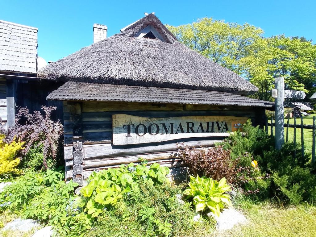 a sign for a town park with a thatch roof at Toomarahva Farmstay in Altja