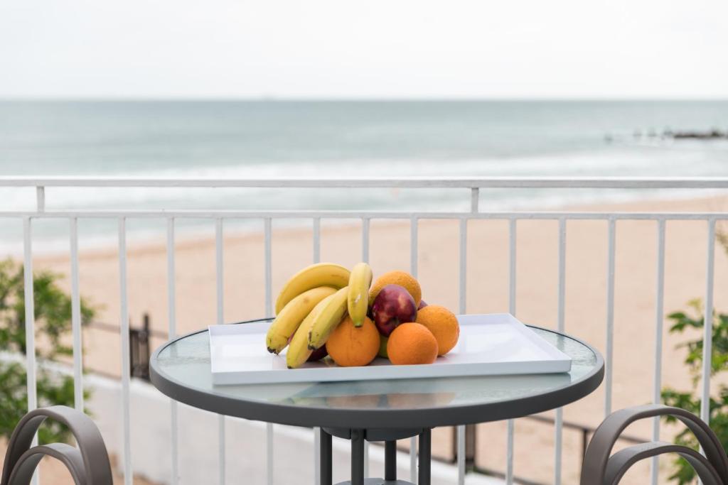 a plate of fruit on a table on the beach at Avenue Palm on the Beach - Avenue Hotels in Eforie Nord