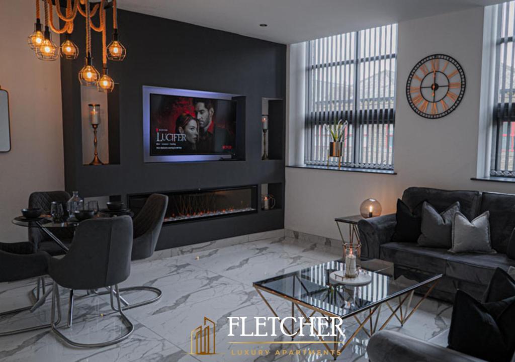 a living room filled with furniture and a tv at Fletcher Apartments in Bradford