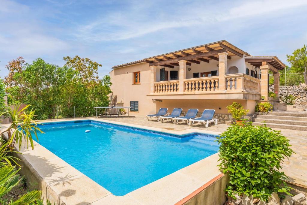 a villa with a swimming pool and a house at Ca Na Ponta in Pollença