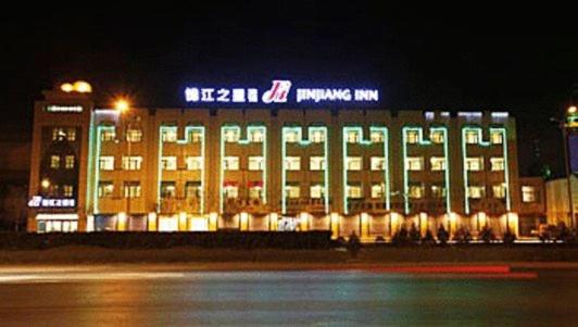 a large building with lights in front of it at night at Jinjiang Inn - Yinchuan New Moon Square in Yinchuan