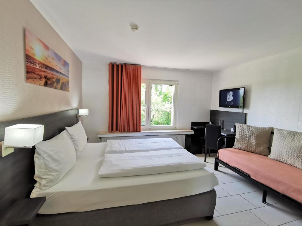 Postel nebo postele na pokoji v ubytování BIVIUS Hotel Restaurant Luxembourg