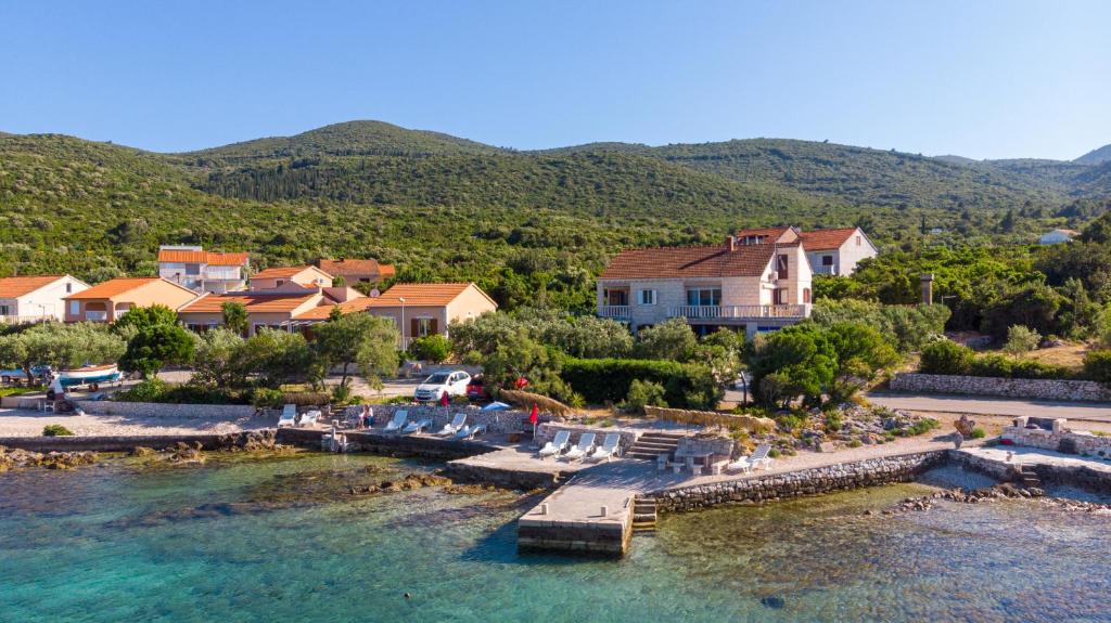 an aerial view of a house and the water at Apartments MAK in Račišće