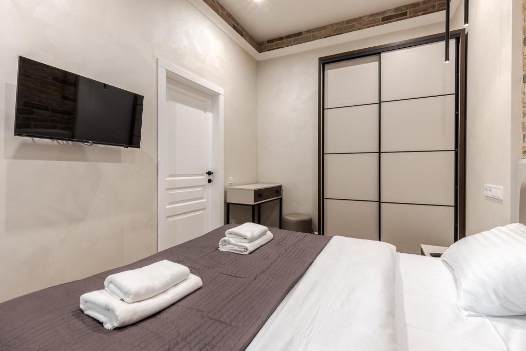 Postel nebo postele na pokoji v ubytování View on Rynok Square apartments