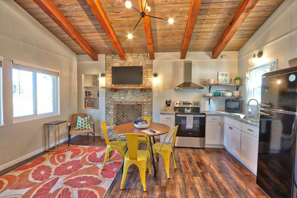 a kitchen with a table and yellow chairs in it at Millies Cottages Unit 3 - Phyllis in Canyon Lake