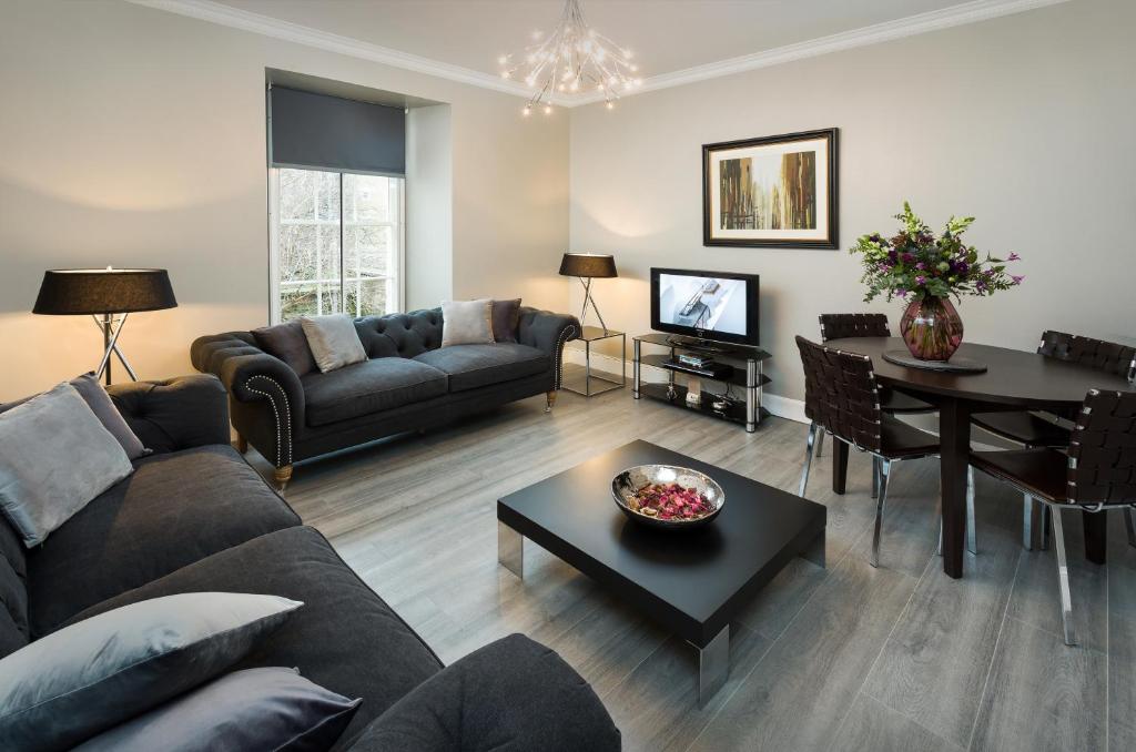 a living room with a couch and a table at Old Town Suites - Nicolson in Edinburgh