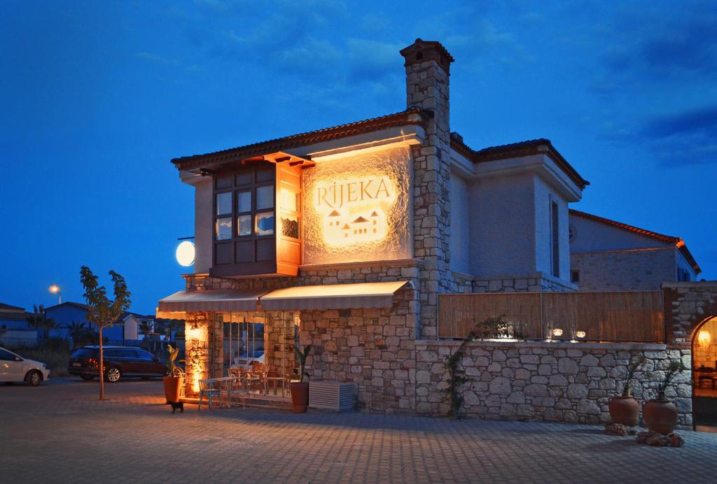 a building with a sign on the side of it at Rijeka Alaçatı in Cesme