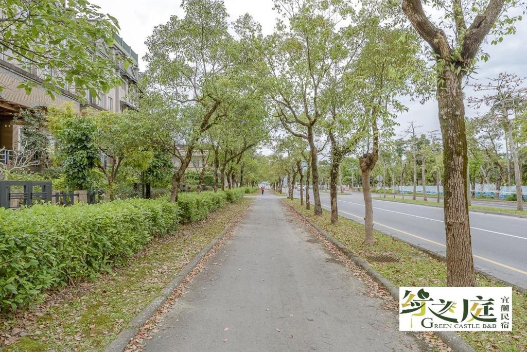 a road with trees on the side of a street at 宜蘭綠之庭民宿 in Luodong