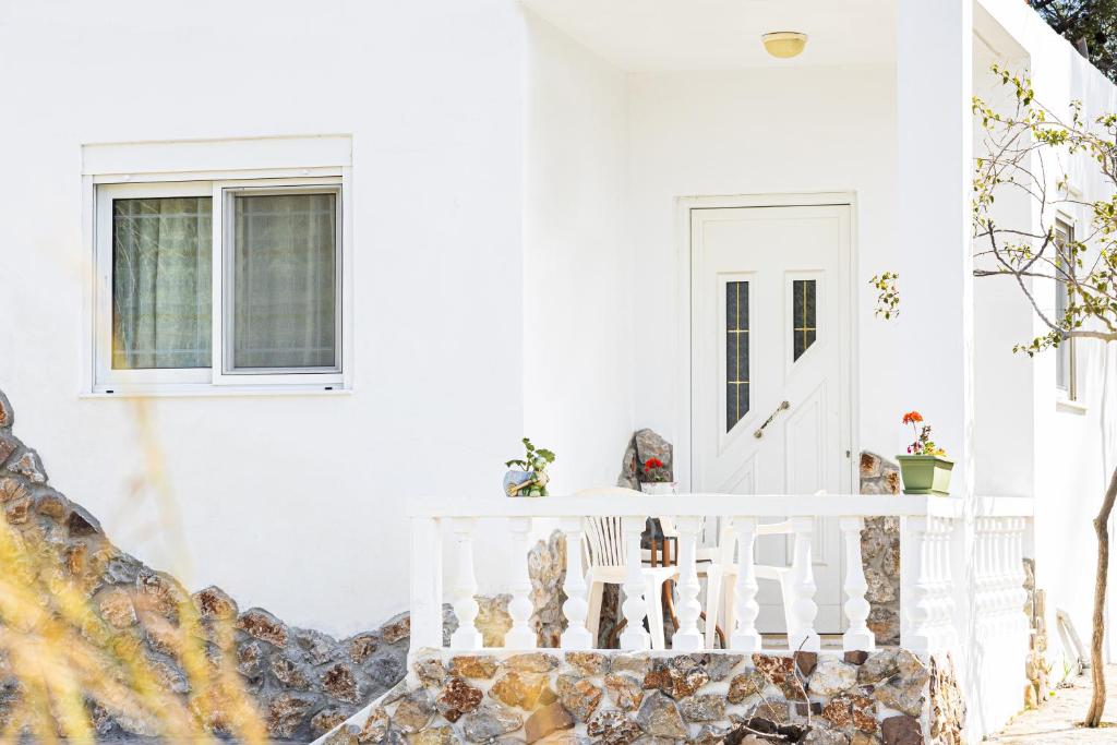 a white room with a staircase and windows at STUDIO ASTERO in Pefki Rhodes