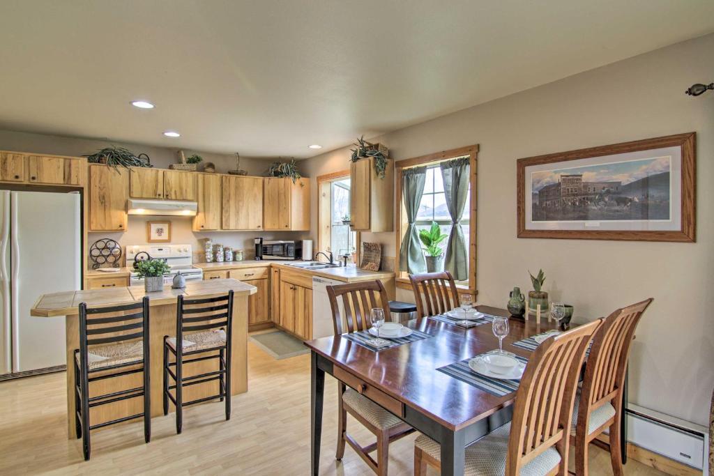 a kitchen with a wooden table and a dining room at Airy Emigrant Townhome with Sweeping Mtn Views! in Emigrant