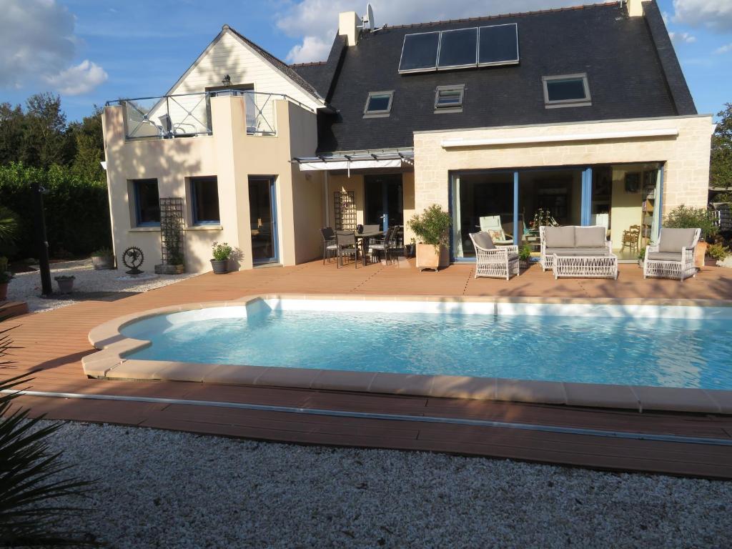 a swimming pool in front of a house at Asphodèle in Ambon