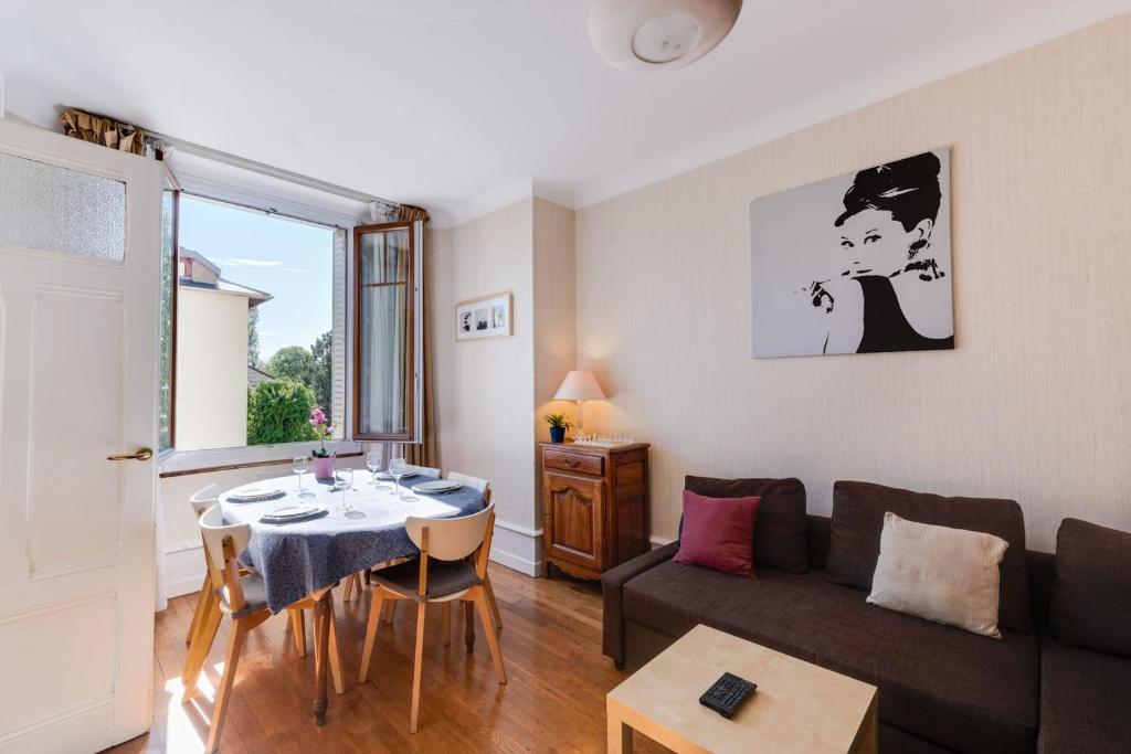 a living room with a couch and a table at Annecy Triangle d'Or - 3 bedroom apartment in Annecy