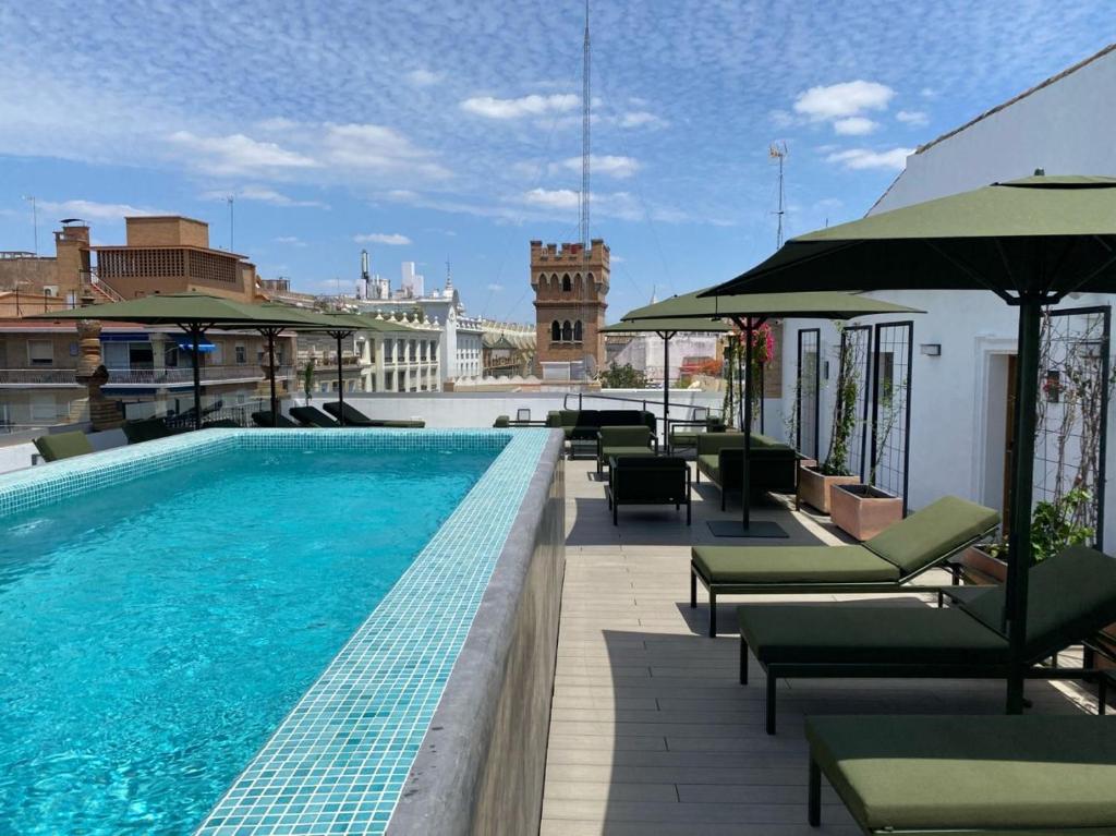 a swimming pool on the roof of a building at Aquitania Home Suites in Seville