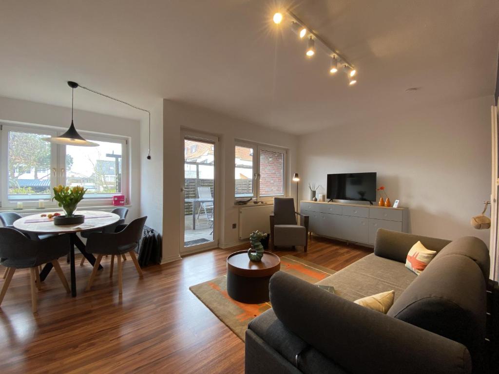 a living room with a couch and a table at Ferienwohnung Dünengraf in Wangerooge