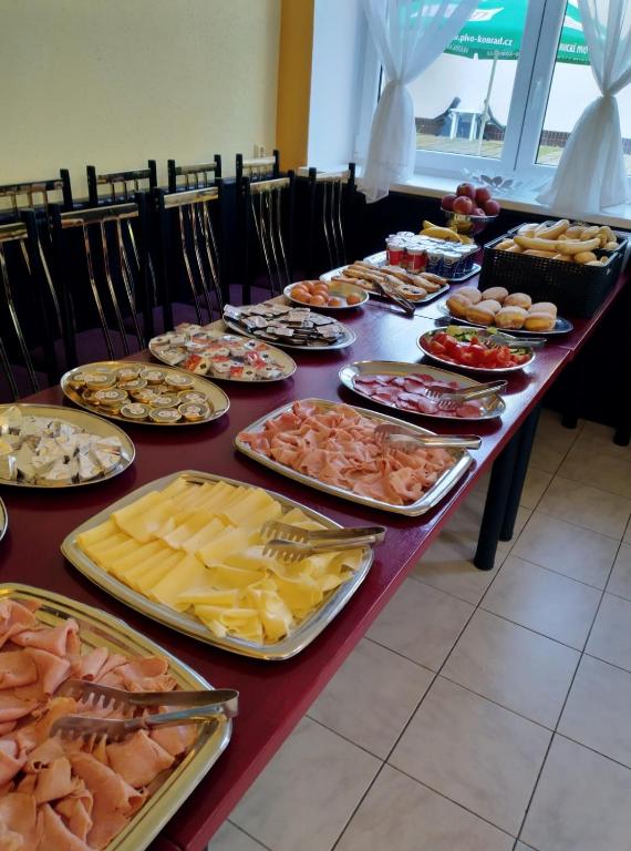 a long table filled with different types of food at Hotel U Jezírka in Liberec