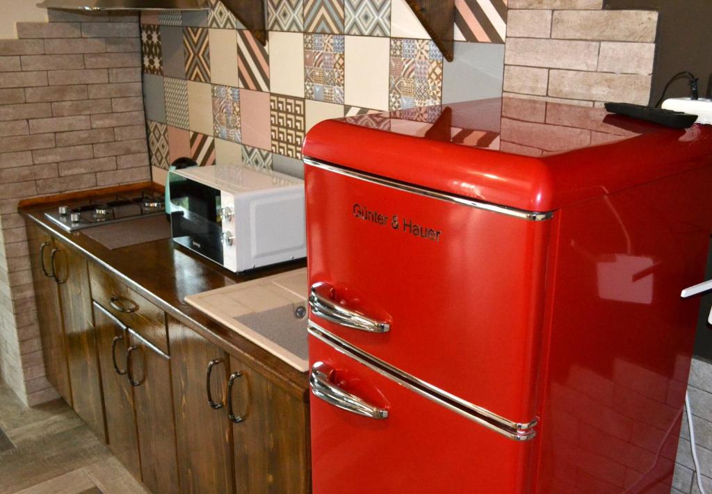 een oude rode koelkast in een keuken bij Апартаменты ПРЕМЬЕР in Kamjanets-Podilsky