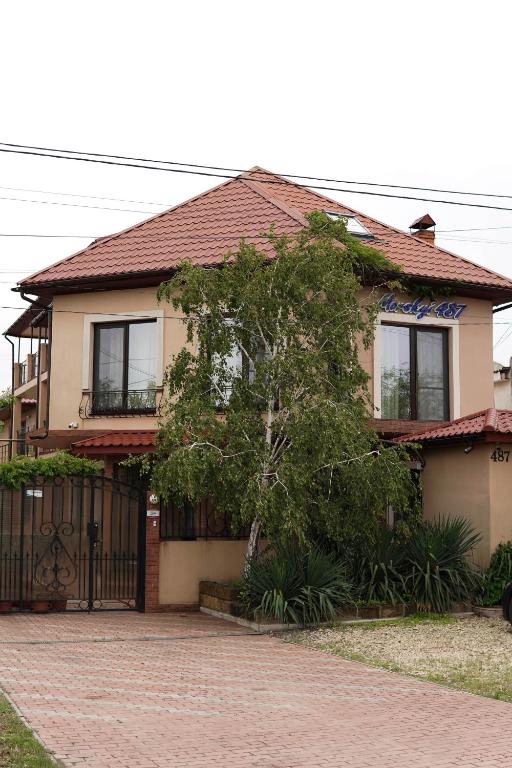 a house with a tree in front of it at Morskyi 487 in Zatoka